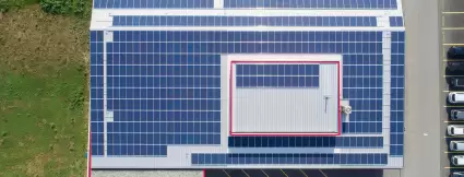 Drone view of the Lugaia company building with a fully installed photovoltaic system on the roof – showcasing sustainable energy use and environmental responsibility.