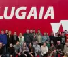 Lugaia Employees in front of the Lugaia Logo