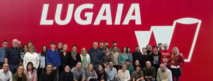 Lugaia Employees in front of the Lugaia Logo